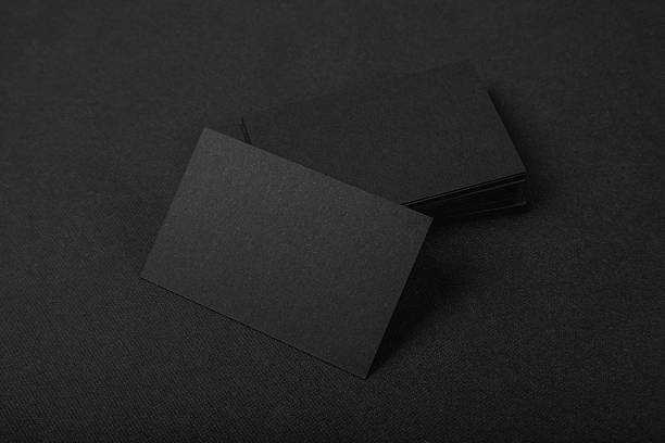 istock Stack Of blank black business cards on textile background 510583426
