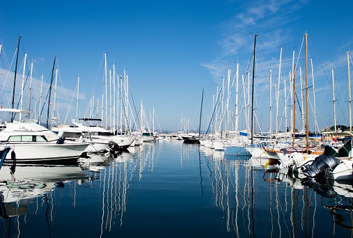 View on  Saint Tropez harbour with white yachts and boats on a beautiful sunny day. France, summer 2015