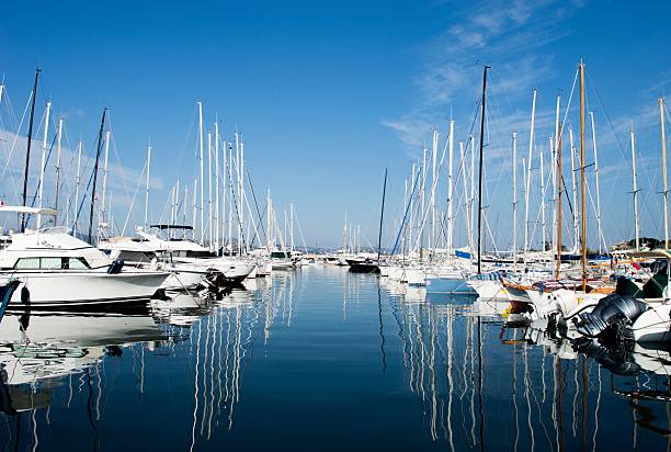 Harbuor with yachts and sailboats Saint Tropez View on  Saint Tropez harbour with white yachts and boats on a beautiful sunny day. France, summer 2015 Marina stock pictures, royalty-free photos & images