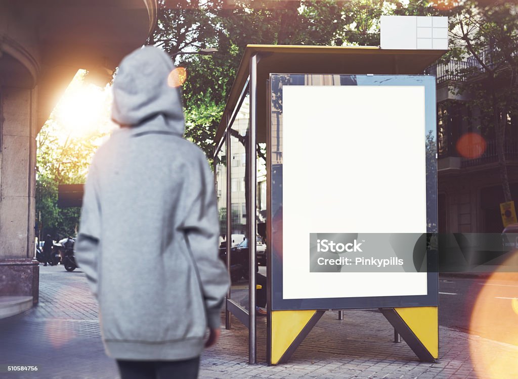 Photo of girl looking at empty lightbox on the bus Photo of girl looking at empty lightbox on the bus stop. Adult Stock Photo