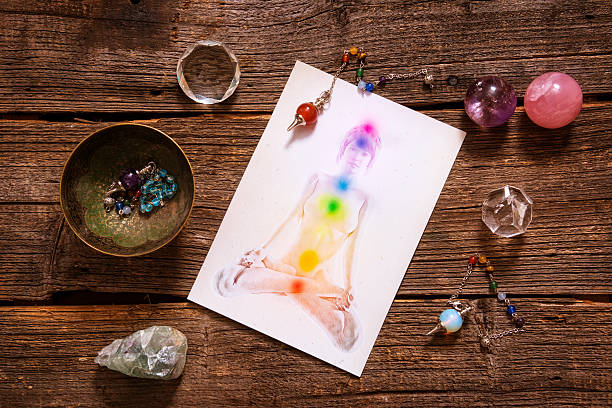 Chakras over a human body Chakras illustrated over human body with natural crystals and pendulum chakra photos stock pictures, royalty-free photos & images