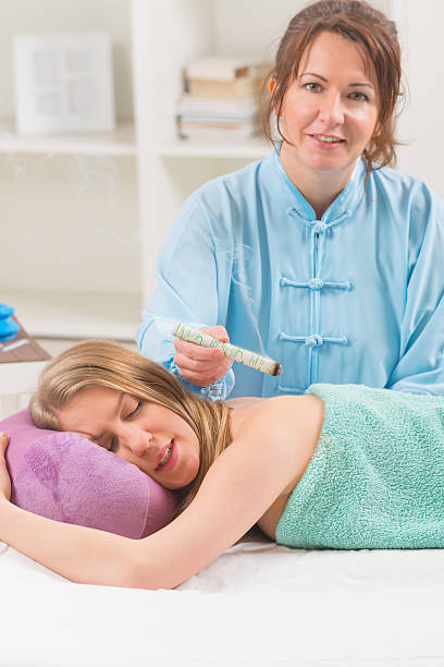 istock Alternative medicine therapist doing moxa treatment 510586542