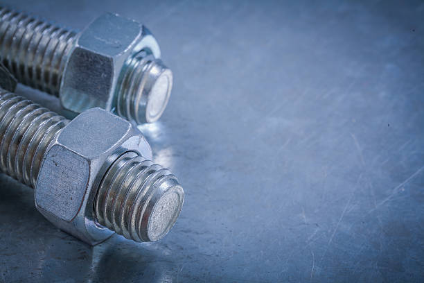 istock Threaded bolt details and screw-nuts on metallic surface constru 510586668