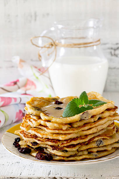 istock Oatmeal Pancakes with honey and raisins on a rustic table 510586928