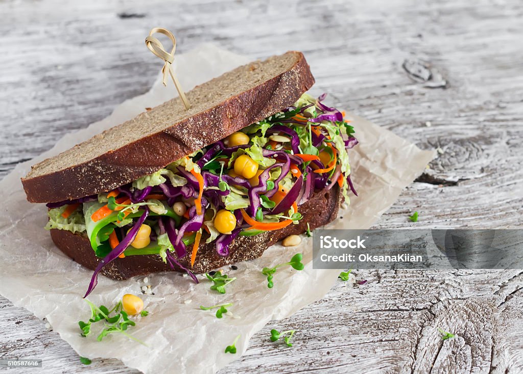 Delicious healthy vegetarian open cole slaw and a chickpea sandwich Delicious healthy vegetarian open cole slaw and a chickpea sandwich. On  light wooden rustic background Sandwich Stock Photo