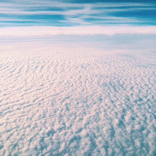 Looking down soft cumulus clouds from an airplane