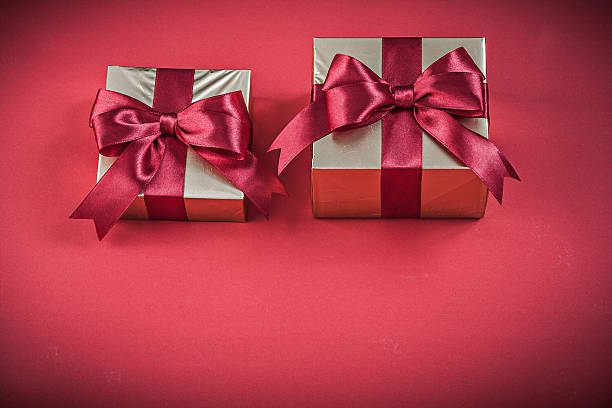 istock Wrapped gift container with bow on red background holidays conce 510587766