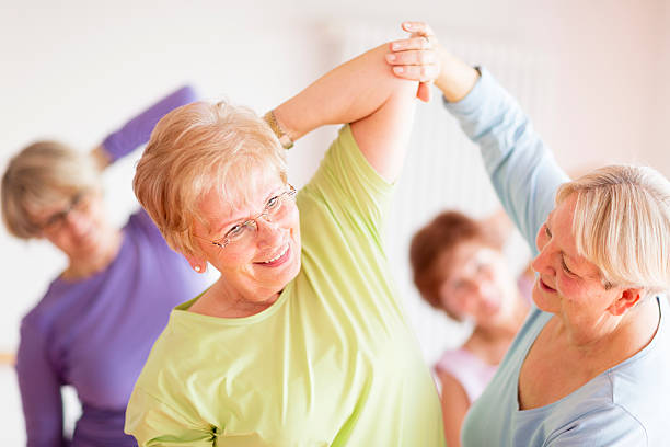 istock instructor with active senior women in yoga class 510589546