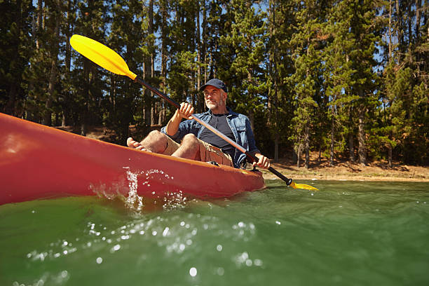istock Mature man paddling a kayak in a lake 510610358