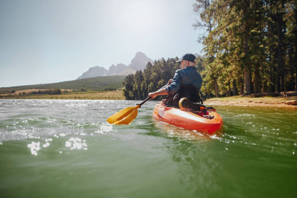 istock Senior man paddling kayak on a summer day 510610662