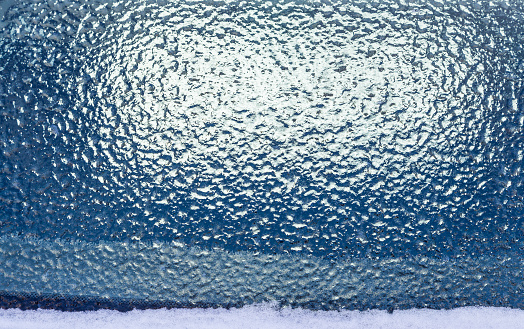 Ice on frozen window after snow storm