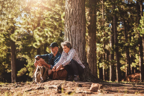 istock Mature couple under a tree with backpacks and compass 510611228
