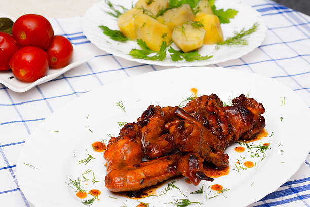 istock chicken  grilled with boiled potatoes and pickled tomatoes 510611488