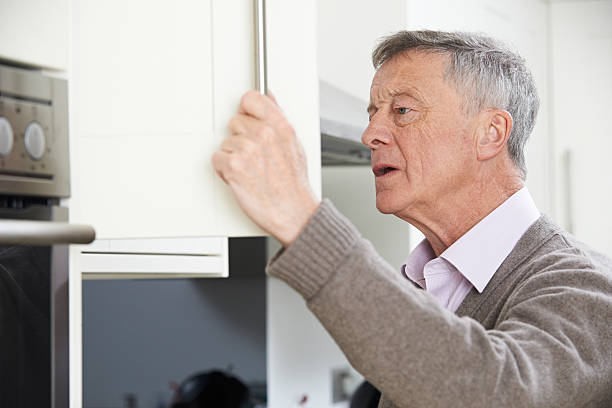 istock Forgetful Senior Man Looking In Cupboard 510611974