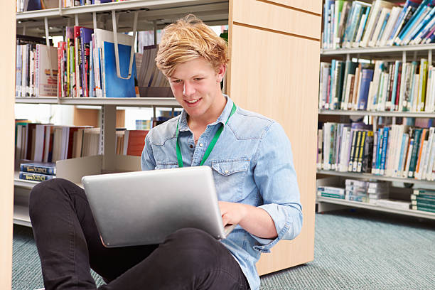 istock Male College Student Studying In Library With Laptop 510613809