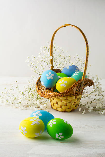 istock Light blue, yellow, green Easter eggs in the basket 510614192