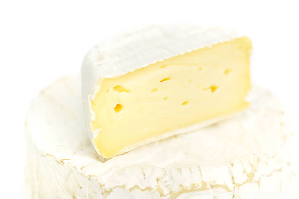 istock Round camembert cheese with a piece on white background 510616184