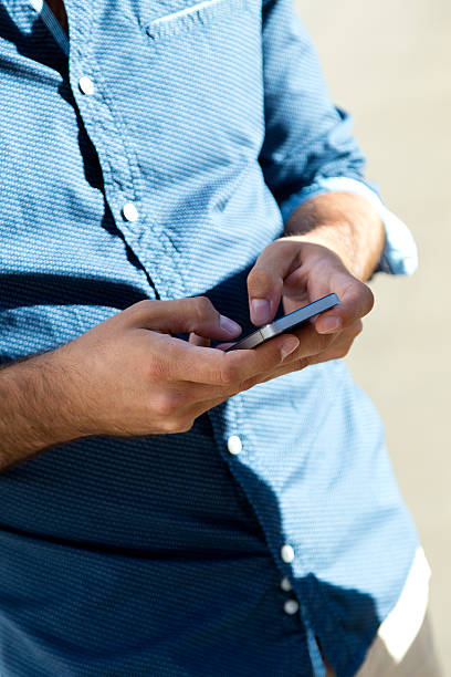 istock Young man using mobile phone in the street. 510616429