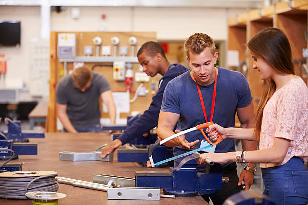 istock Teacher Helping Students Training To Be Electricians 510616847