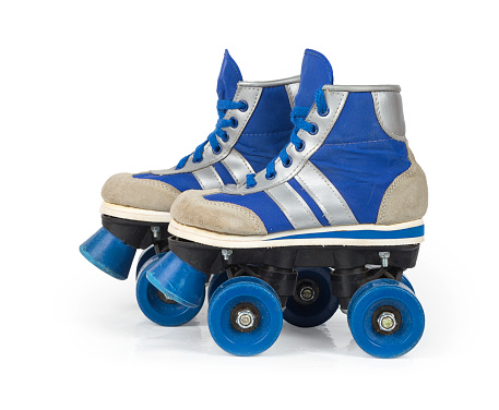 Old blue rollerblades isolated on white background
