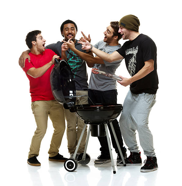 Social group of young men having a BBQ