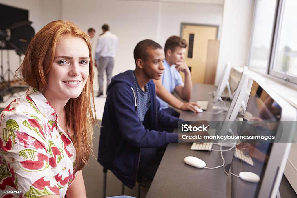 College Students Using Computers On Media Studies Course College Students Using Computers On Media Studies Course Smiling To Camera 16-17 Years Stock Photo