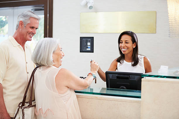 istock Senior Couple Checking In At Hotel Reception 510619043