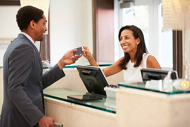 istock Businessman Checking In At Hotel Reception Front Desk 510619135