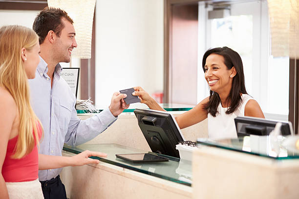 istock Couple Checking In At Hotel Reception 510619223