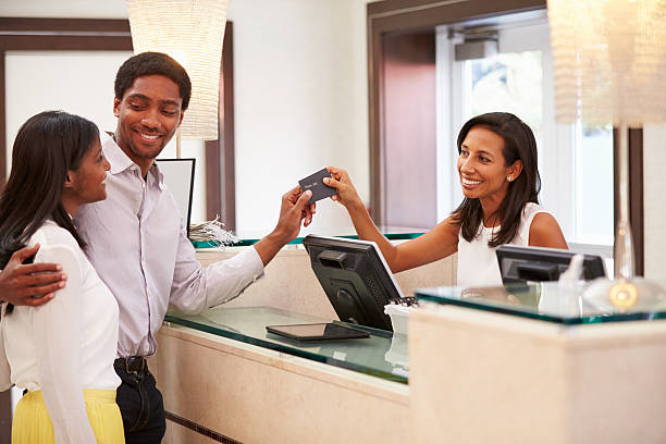 istock Couple Checking In At Hotel Reception 510619305