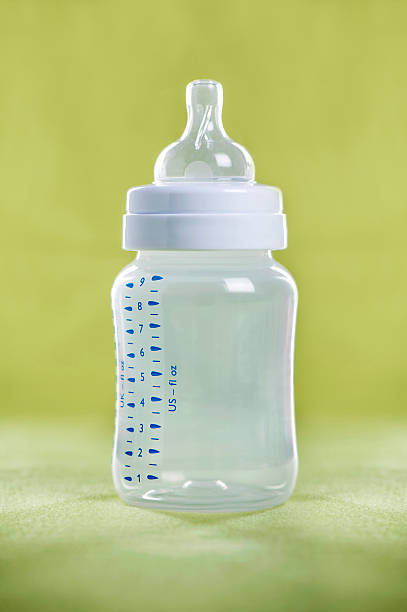 istock Baby milk bottle on a green sheet 510619794