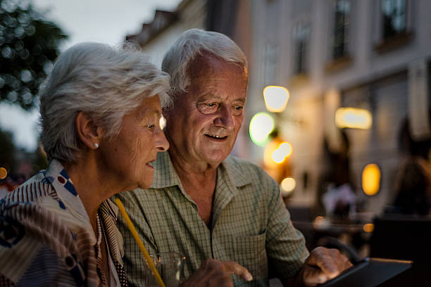istock Senior couple using digital tablet in the city 510621280