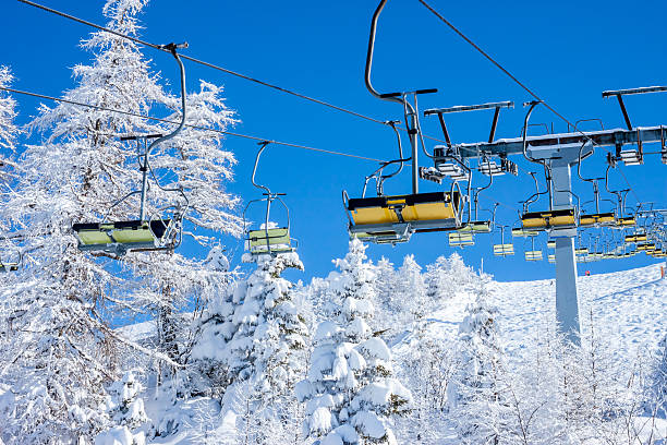 Chair ski lift Chair ski lift on background of sky and winter forest krvavec stock pictures, royalty-free photos & images