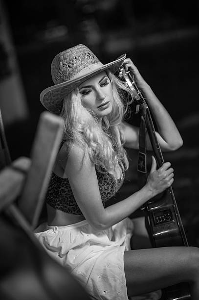 istock Girl with straw cowboy hat and guitar 510624770
