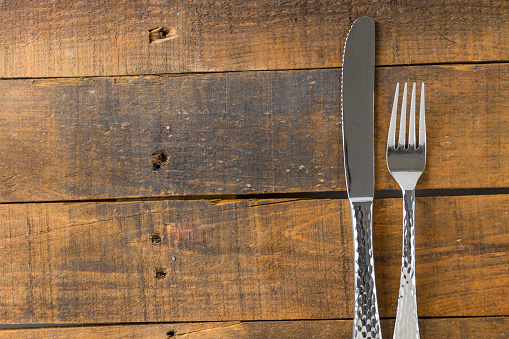 fork and knife on wood background
