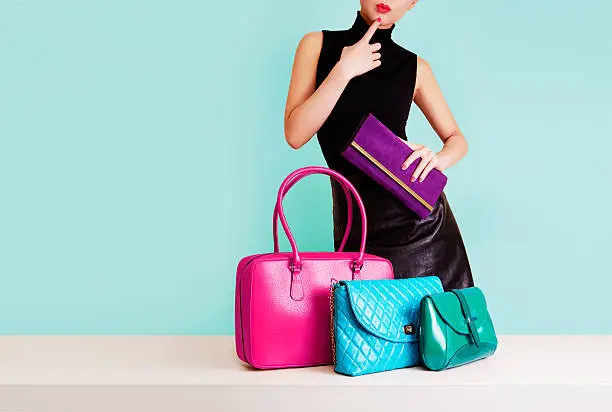 Photo of Woman thinking with many colorful bags. Shopping. Fashion image.
