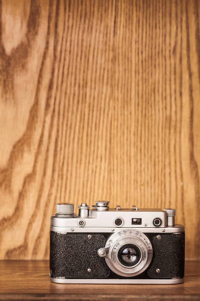 istock Vintage camera on wooden background. 510626118