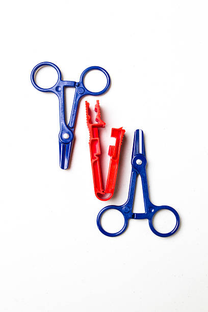 Blue and Red Dialysis Clamps Clamps used in peritoneal dialysis transfers. peritoneal dialysis photos stock pictures, royalty-free photos & images