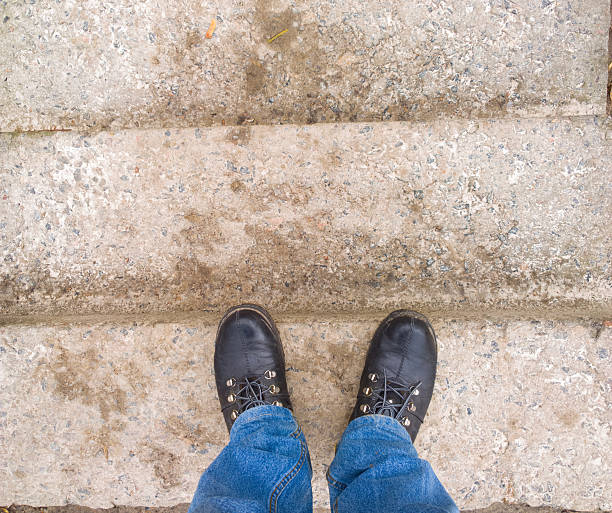 Photographed with mobile phone. Feet on the stairs. 