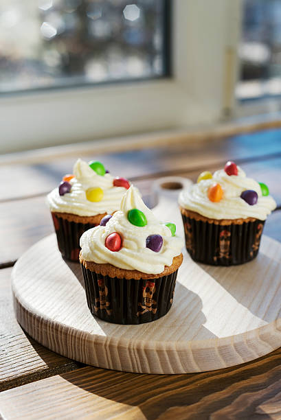 istock Creamy cupcakes with color drops 510629246