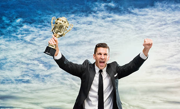 istock Cheerful businessman cheering with trophy 510629840