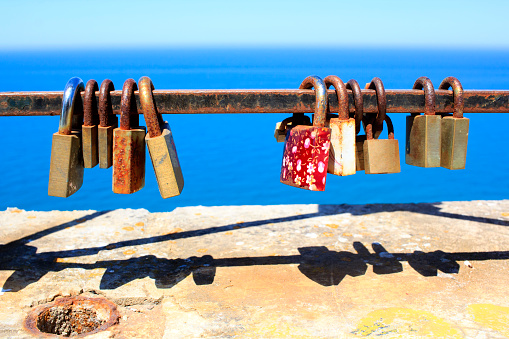 Metal padlocks on the bridge symbolizing unbreakable love and bonding. 