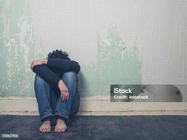 Sad Young Man In Empty Room Stock Photo - Download Image Now - Suicide, Men, Sitting