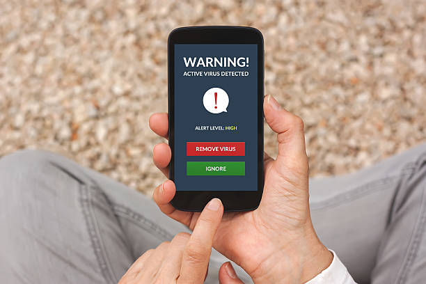istock Hands holding smartphone with virus alert on screen 510631218