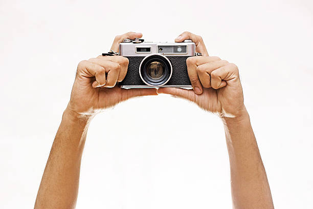 istock Hands Holding A Wintage Camera isolated on white 510632420