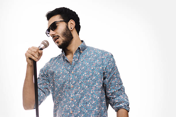 Young Men Holding Mic Wearing Glasses And Singing A Song stock photo