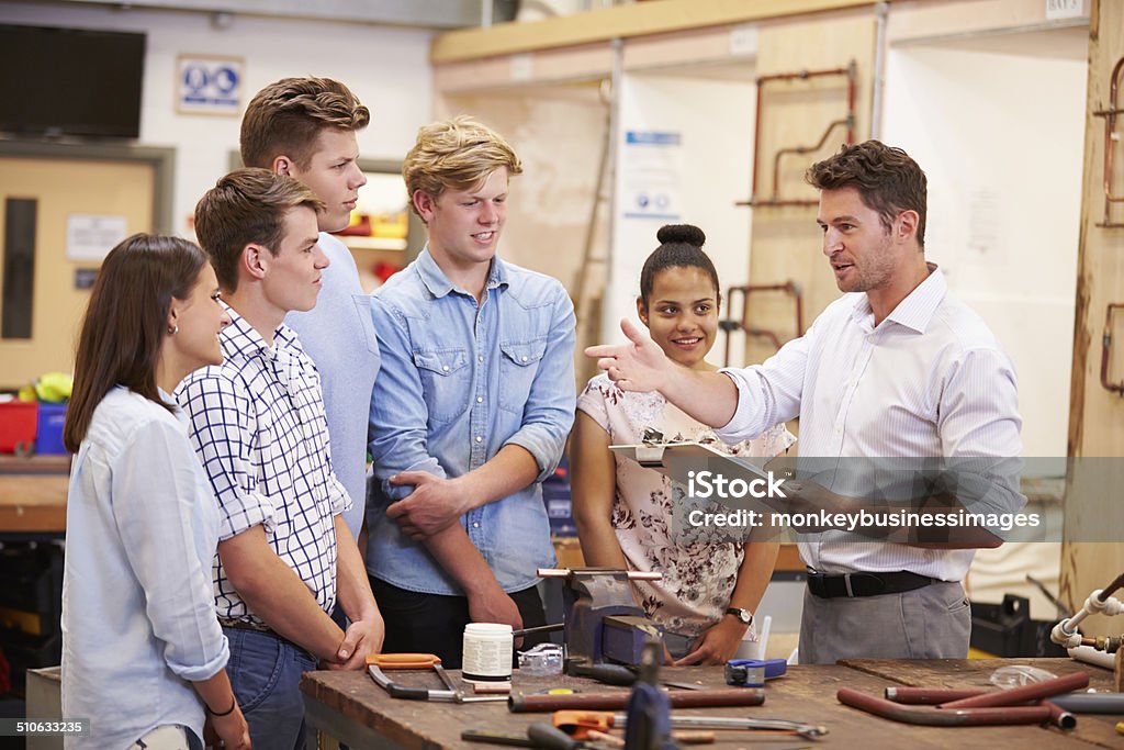 Teacher Helping College Students Studying Plumbing Teacher Helping College Students Studying Plumbing Holding A Clipboard Trainee Stock Photo