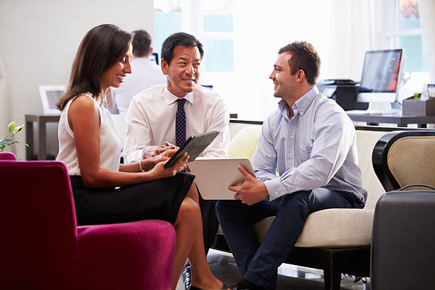 istock Three Businesspeople Having Meeting In Hotel Lobby 510633267
