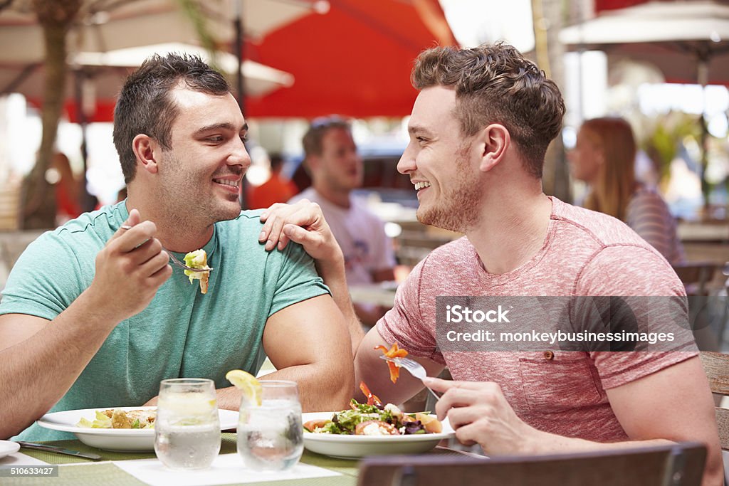 Male Couple Enjoying Lunch In Outdoor Restaurant Gay Person Stock Photo