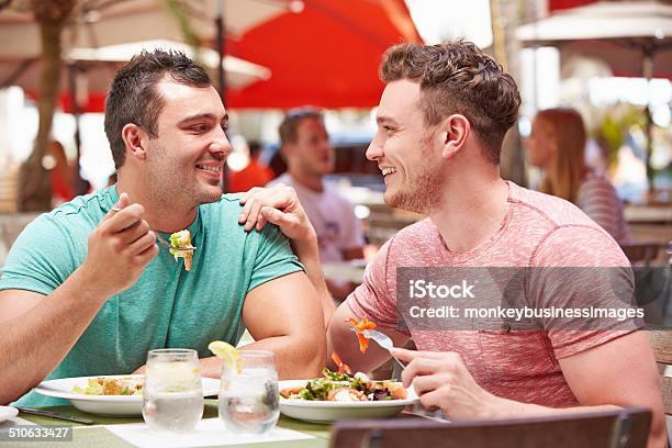 Male Couple Enjoying Lunch In Outdoor Restaurant Stock Photo - Download Image Now - Gay Person, Restaurant, Gay Couple